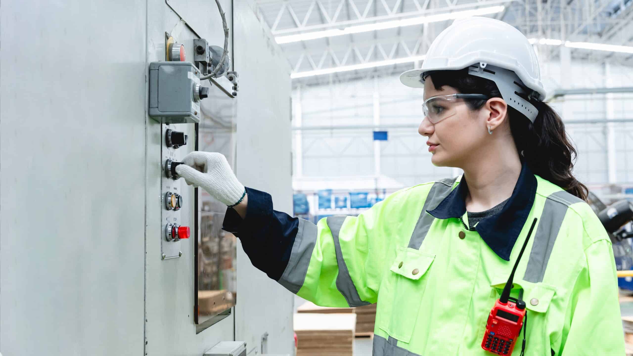 Caucasian,Female,Technician,Adjusting,Industrial,Control,Panel,While,Operating,Packaging Equipment Breakdown Insurance Georgia